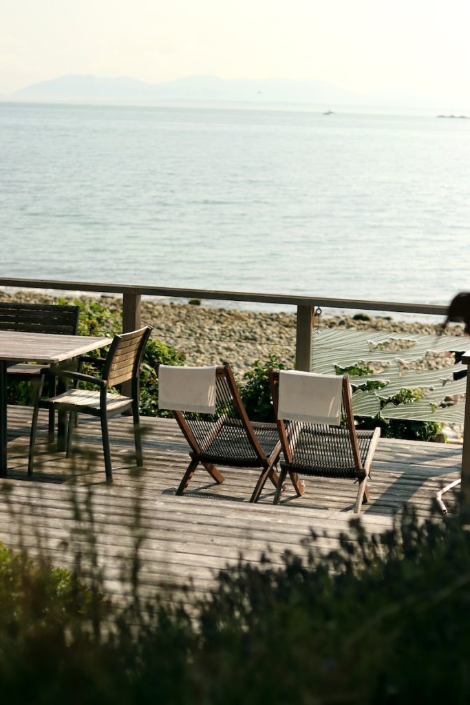 tables and chairs near seashore